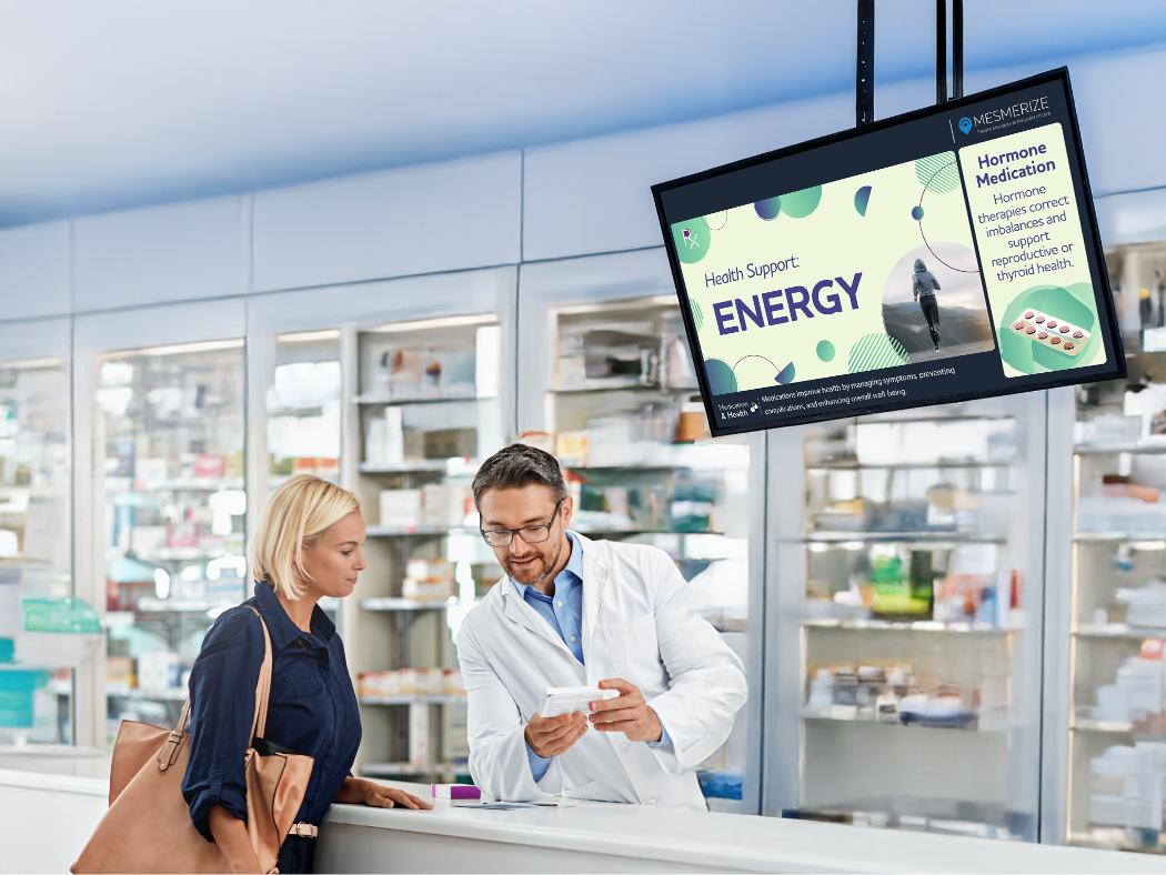 Doctor pointing to information displayed on digital screen for patient to read.