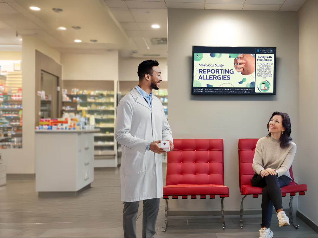 Kid playing with toys in waiting room, as patients read info displayed in a digital screen on the wall.