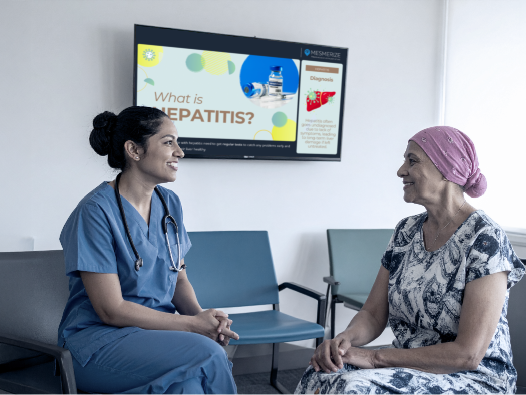 Kid playing with toys in waiting room, as patients read info displayed in a digital screen on the wall.